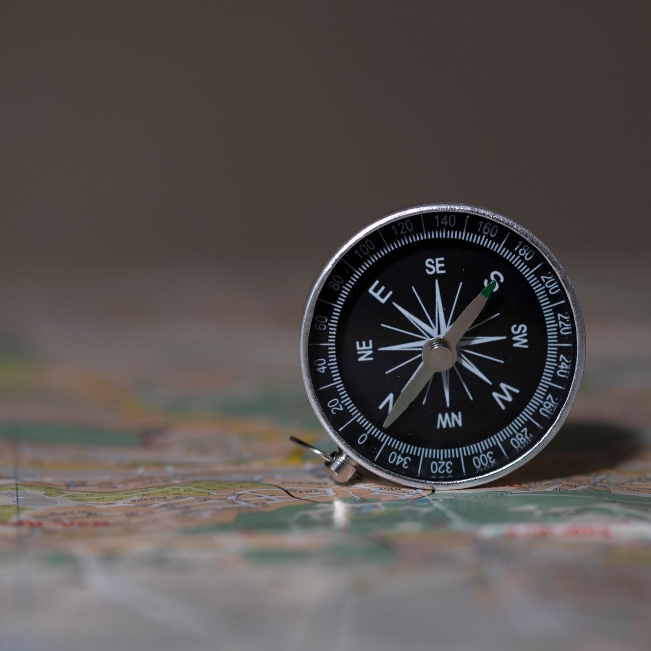 compass on the background of the map travel concept route planning find your direction in life