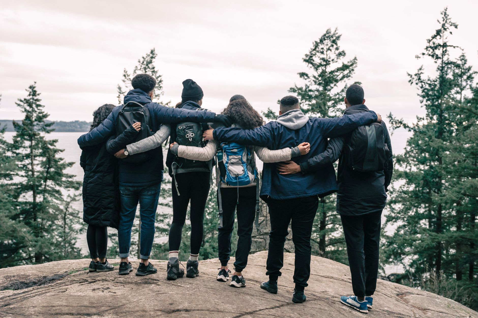 people friends hiking cliff